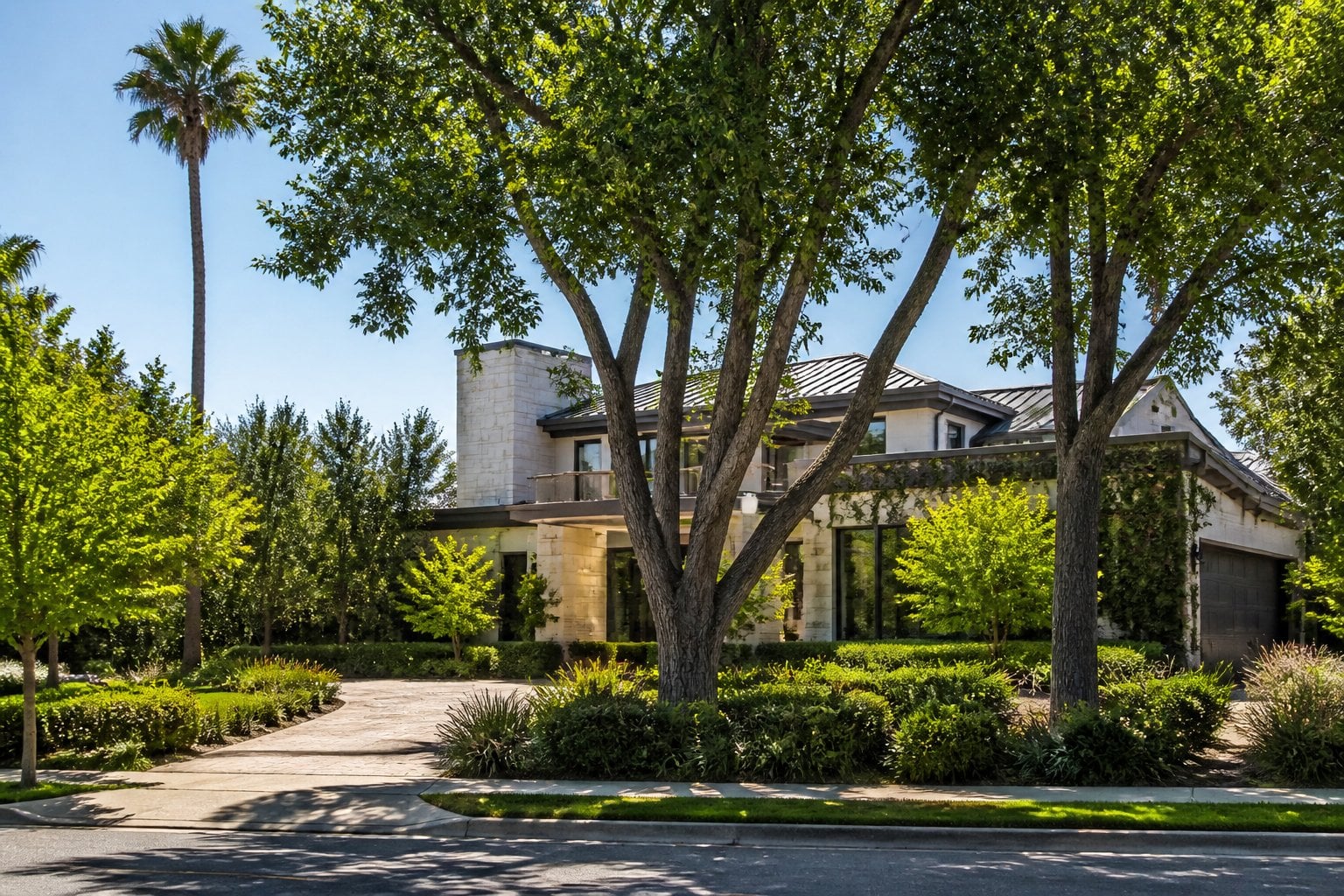 A luxurious home in a landscaped Palo Alto residential neighborhood under bright California sunlight.