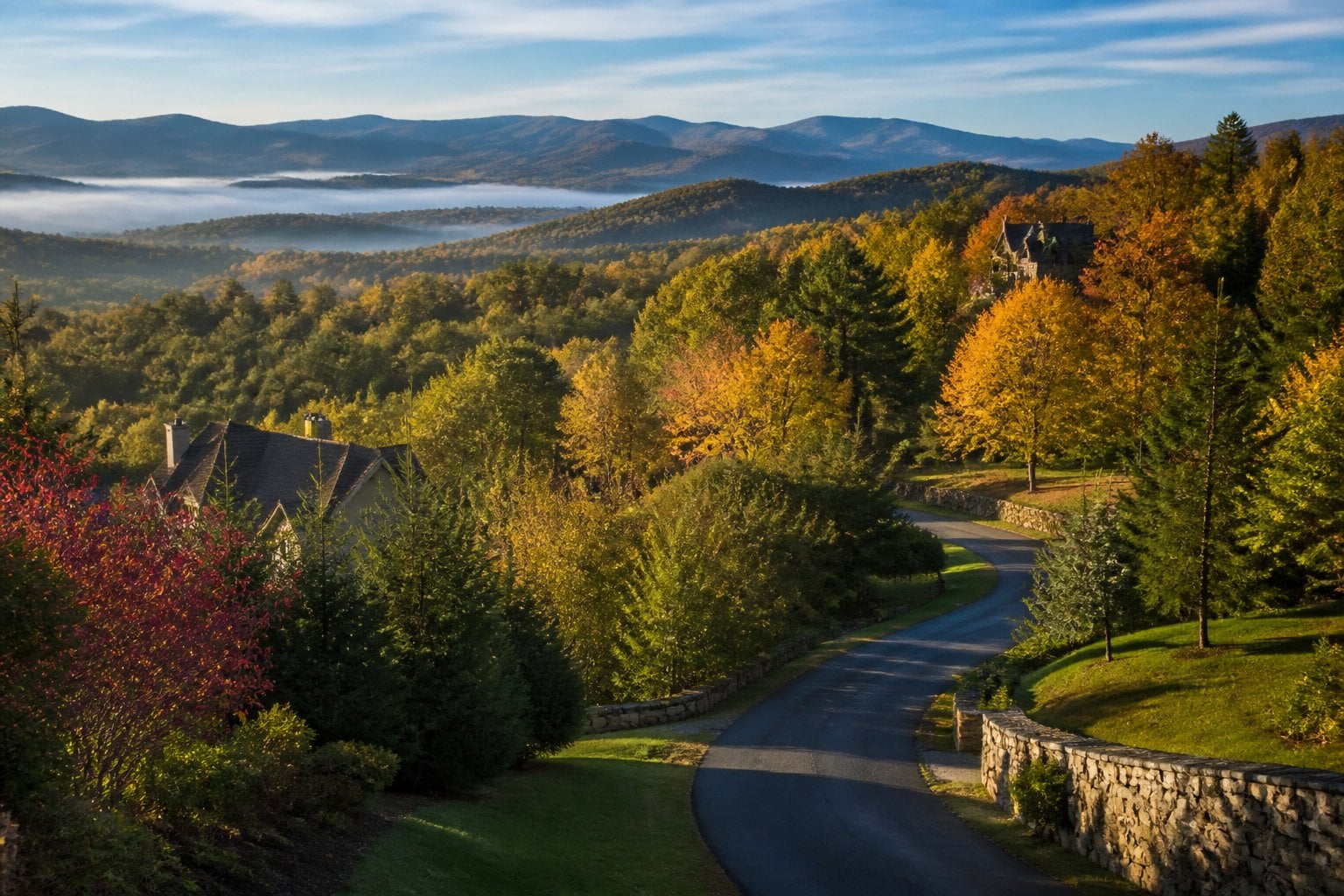 A scenic view of an upscale mountain community surrounded by forested Green Mountain ridges in autumn.