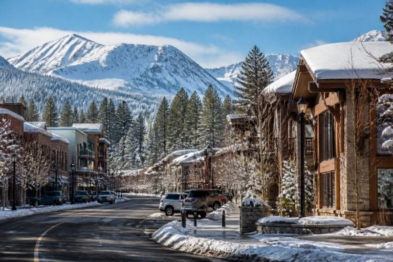 A snowy mountain town in Truckee, California, surrounded by pine trees and rugged Sierra Nevada peaks.